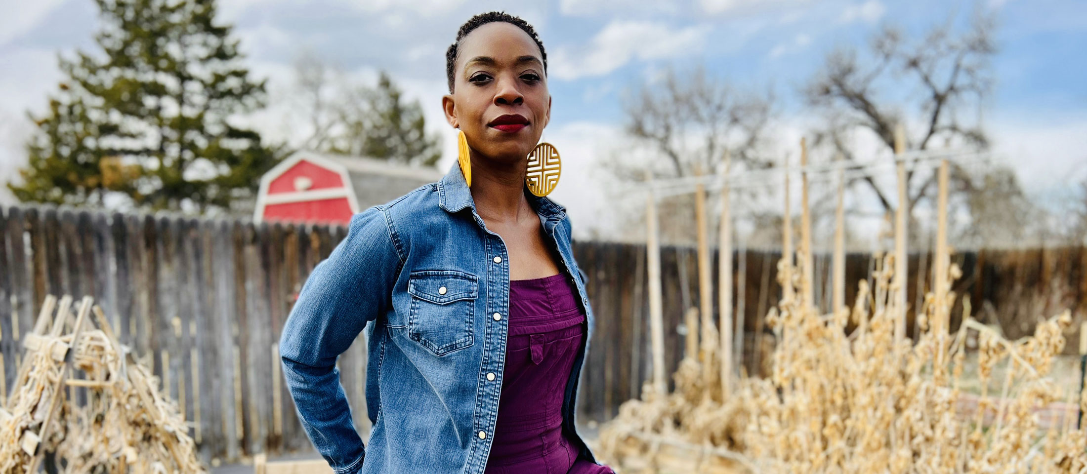 Woman posing in purple overalls